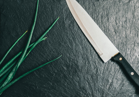 Dill, parsley, green onions lie on the kitchen cutting boardの写真素材