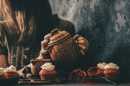 Red cupcake and tea in home kitchen roomの写真素材