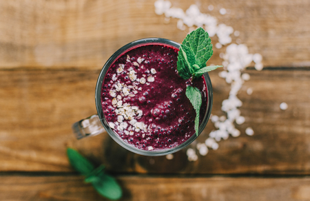 Glass of homemade blueberry  and strawnerry smoothie, on wooden rustic background. Healthy breakfast theme. With copy space.の写真素材