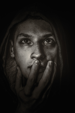 Blacl and white dramatic photo of the young manの写真素材