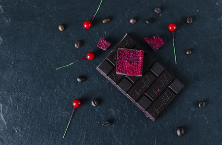 Dark chocolate with red berrys on black tableの写真素材