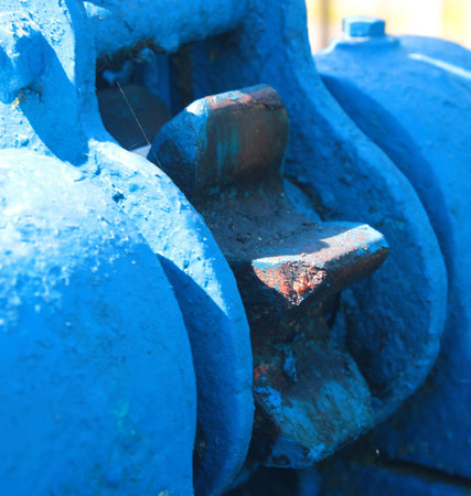 Detail of a blue water pump, closeup of photo.