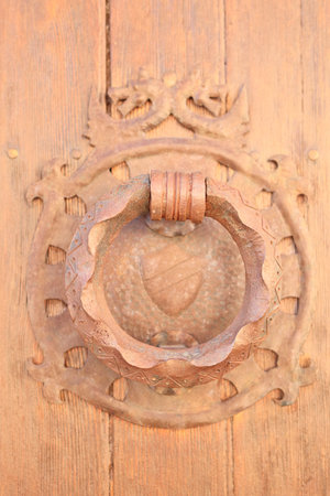 Door knocker in the shape of a heart on a wooden doorのeditorial素材