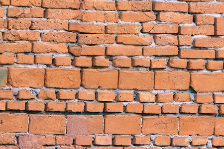 An old brick wall composed of bricks of different sizes.