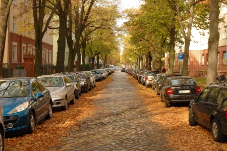 POTSDAM, GERMANY - OCTOBER 20  Street, cars, buildings and autumn leaves somewhere in Potsdam Germany 20 10 2013のeditorial素材