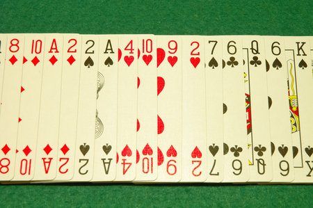 Row of poker cards on poker table 