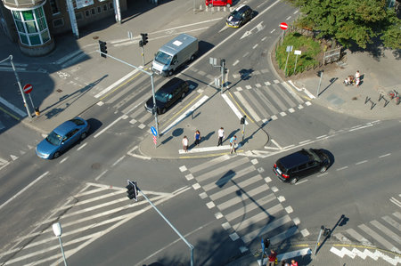 Poznan, Poland - July 11, 2014: Unidentified people and traffic on crossing on Poznanska street in...