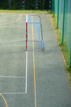 Gate on empty small school football fieldの写真素材