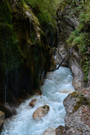 Stream between rocks in deep ravine in mountains.の写真素材