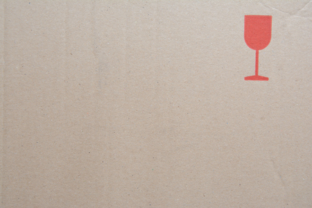 Brown cardboard texture with red glass - fragile symbolの写真素材