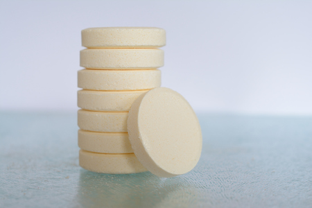 Pile of soluble tablets on glass table top closeup. Shallow depth of field.の写真素材