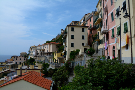 Riomaggiore, Italy - September 4, 2016: Buildings in Riomaggiore city in Liguria, Italy.  One of five Cinque Terre cities (unesco world heritage). Unidentified people visible.のeditorial素材