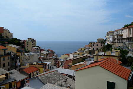 Riomaggiore, Italy - September 4, 2016: Buildings in Riomaggiore city in Liguria, Italy.  One of five Cinque Terre cities (unesco world heritage). Unidentified people visible.のeditorial素材