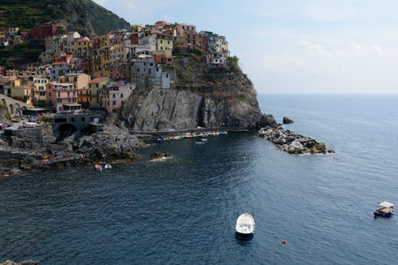 Manarola, Italy - September 4, 2016: Small bay and port in Manarola city in Liguria, Italy.  One of five Cinque Terre cities (unesco world heritage). Unidentified people visible.のeditorial素材