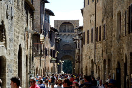 San Gimignano, Italy - September 6, 2016: Street in San Gimignano city in Tuscany, Italy. Unidentified people visible.のeditorial素材