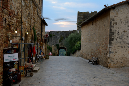 Monteriggioni, Italy - September 7, 2016: Buildings and narrow street in Monteriggioni city in Tuscany, Italy. Unidentified people visible.のeditorial素材