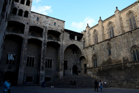 Barcelona, Spain - December 3, 2016: Buildings on Buildings on Placa del Rei square in Barcelona city, Spain. Unidentified people visible.のeditorial素材