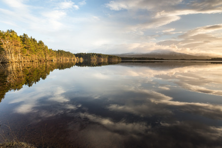Loch Garten and cloud  reflections in the Cairngorms National Park of Scotland.の写真素材