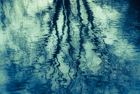 Reflection of trees in lakeの写真素材