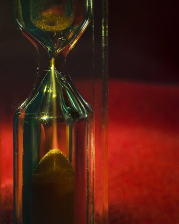 A timer hourglass with sand running through the bulbs. A concept of measurement of passing time.の写真素材