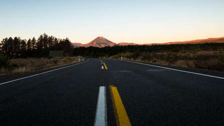 Road towards Mt Ruapehu at sunset in Tongariro National Park, New Zealandの写真素材