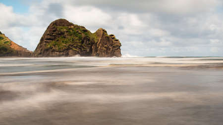 Long exposure image of Piha beach showing the movement of wavesの写真素材
