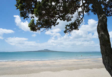 Summer at Takapuna beach with views of Rangitoto Island and people playing on the beach, North Shore, Aucklandの写真素材