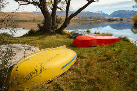 Colorful rowing boats on the foreshore of Lake Alexandrina in autumn, Mackenzie Country, Canterbury, New Zealand.の写真素材