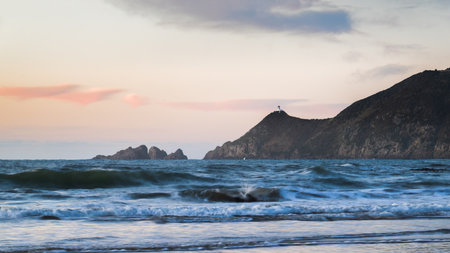 Nugget Point Lighthouse at sunrise, view from Kaka Point beach. Catlins, Southland.の写真素材