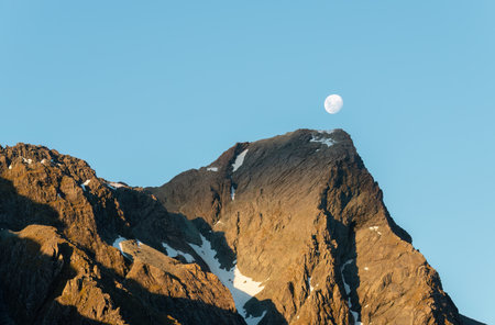 Moon rising above the mountains by Lake Mackenzie at sunset. Routeburn Track, one of the great walks of New Zealand.の写真素材