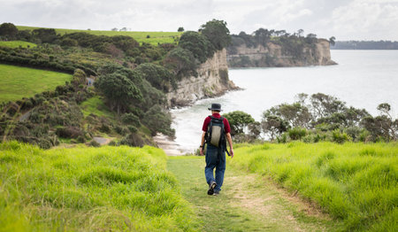 Man walking the Long Bay coastal walk. Auckland.の写真素材