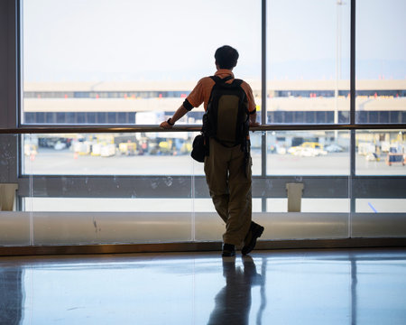 Man looking out of the window at the airport.の写真素材