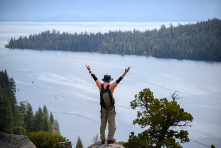 Tourist raising arms at Emerald Bay. Lake Tahoe. California.の写真素材