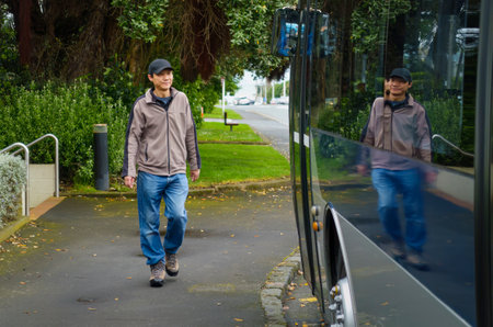 Man walking to the bus stop.の写真素材