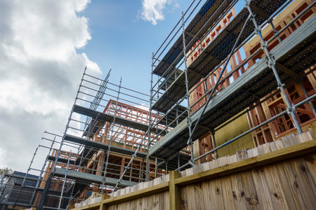 Residential houses under construction with metal scaffolding around them. Auckland.