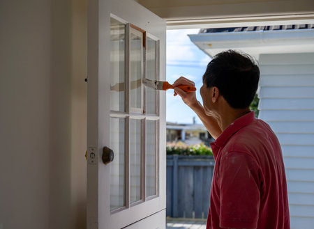 Man painting door frames with a paint brush. Home renovation project.の写真素材
