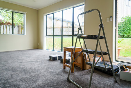 Empty home with ladder, tools and curtains on the floor. Home renovation project. Auckland.の写真素材