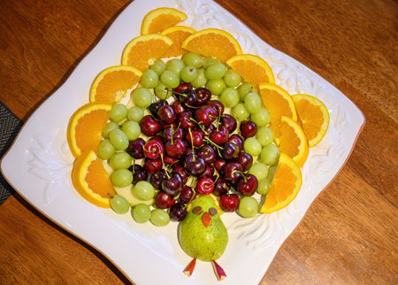 Homemade peacock fruit platter on the dinner table. Home cooking and entertainment.の写真素材