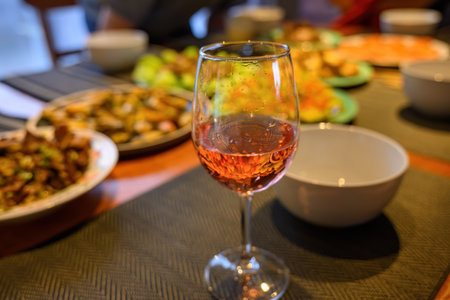 Drinks and dishes on the dinner table. Out-of-focus people around the table. Home cooking and entertainment for Christmas.の写真素材