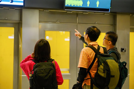 A group of tourists checking the information display board in the subway stationの写真素材