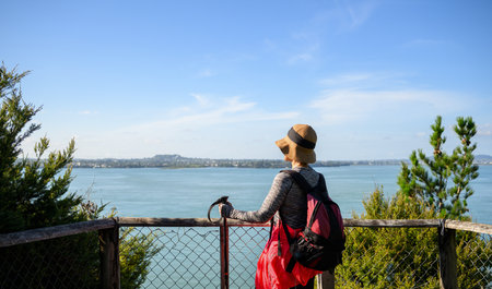 Woman enjoying the view of Waitemata Harbour from Kauri Point Centennial loop track. Auckland.の写真素材