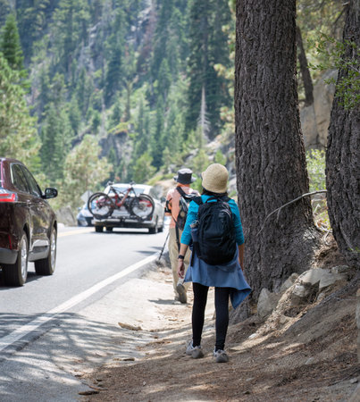 People walking on the side of busy Emerald Bay Road. Lake Tahoe. California.