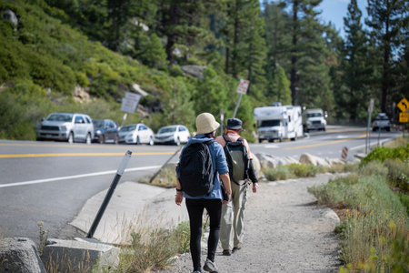 Cars parked along the busy Emerald Bay Road. People walking on the side of the road. Lake Tahoe. California.の写真素材