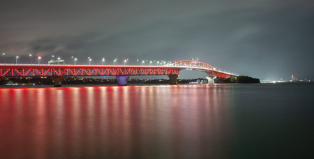 Red lights glow on Auckland Harbour Bridge in support of annual Poppy Day.の写真素材