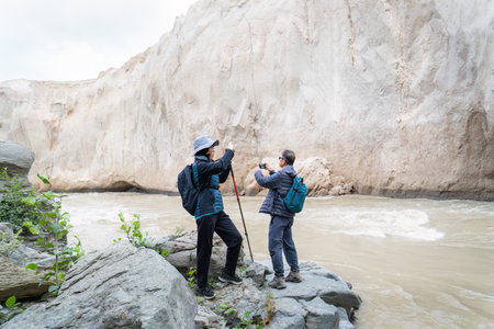 Valley of Ten Thousand Smokes. Couple taking photos using smartphones. Katmai National Park and Preserve. Alaska. USA.の写真素材