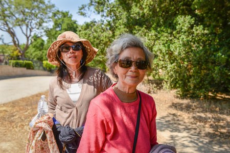 Senior woman walking with daughter. Los Gatos. Santa Clara County. California.の写真素材