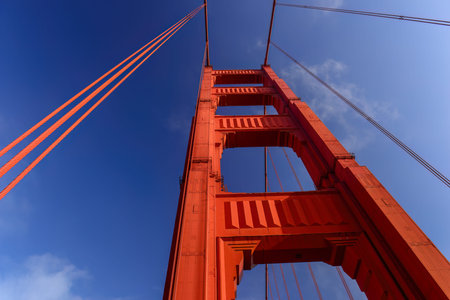 Low angle view of the orange tower of Golden Gate Bridge. San Francisco. California.
