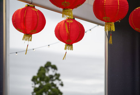 Red lanterns hanging under doors and ceiling. Chinese New Year celebration. Auckland.の写真素材