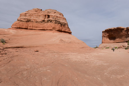 Man hiking Delicate Arch trail in Arches National Park. Utah.の写真素材