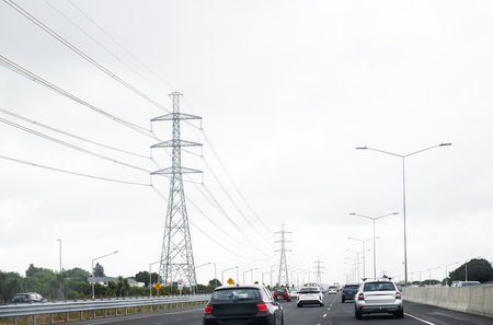 Transmission pylons and power lines along the busy motorway. Auckland.の写真素材